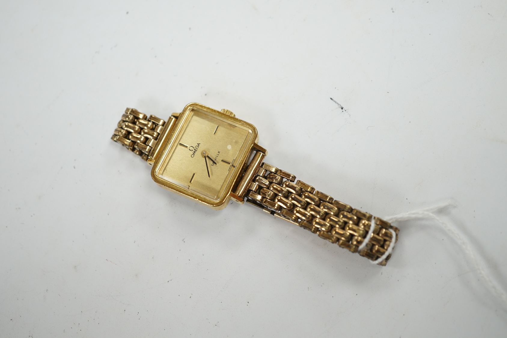 A lady's steel and gold plated Omega De Ville manual wind wrist watch, on an associated gold plated bracelet. Condition - poor to fair